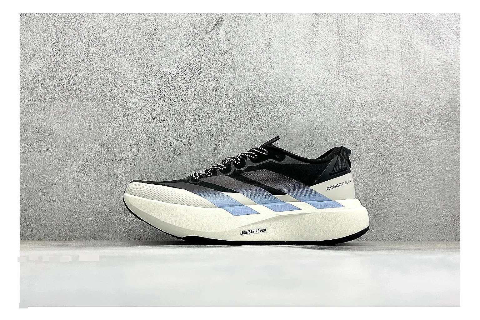 Adidas Adizero Evo Black shopping brief photo showing black racing upper, sculpted white sole, Adidas striping, and lightweight performance silhouette