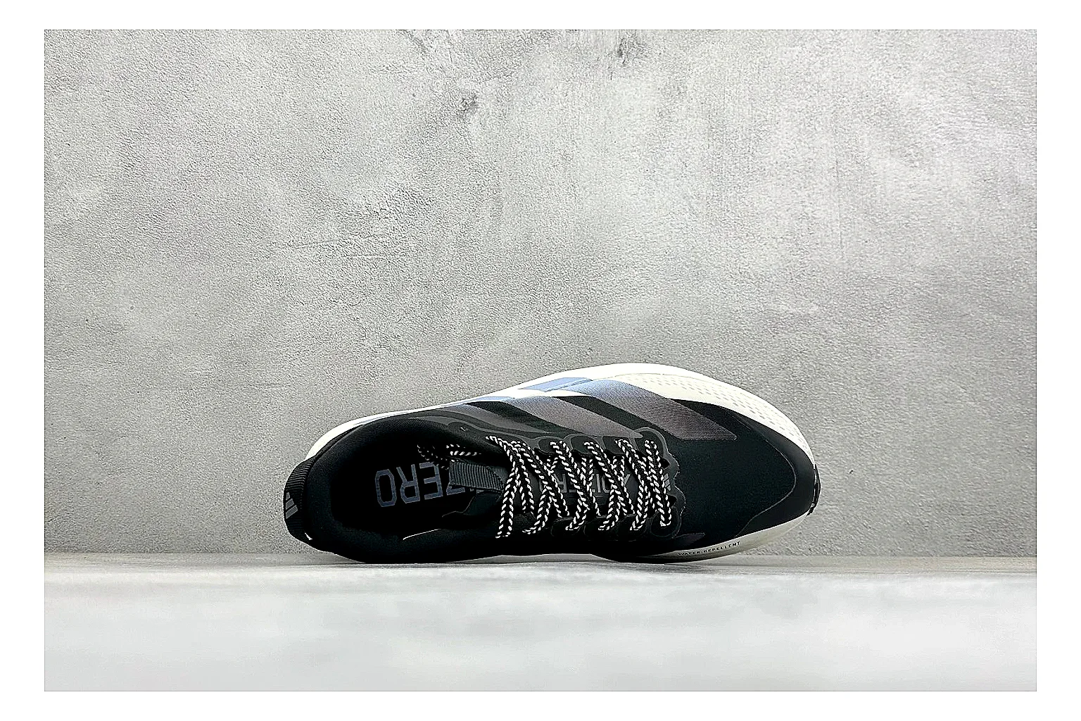 Adidas Adizero Evo Black shopping brief photo showing black racing upper, sculpted white sole, Adidas striping, and lightweight performance silhouette thumbnail 5