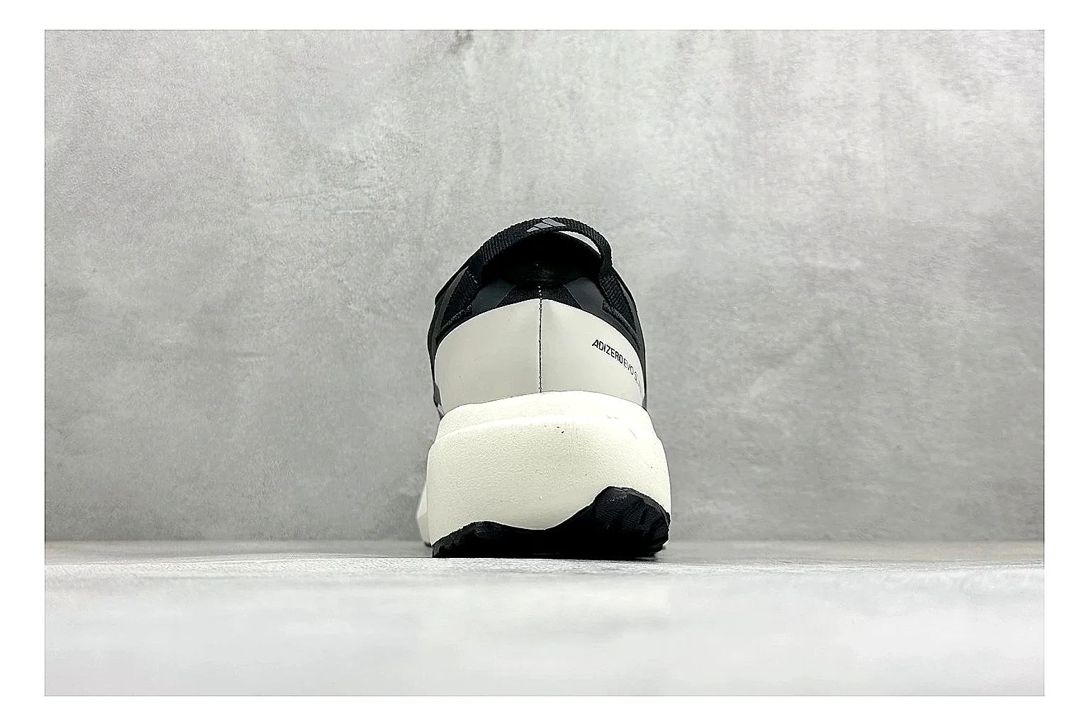 Adidas Adizero Evo Black shopping brief photo showing black racing upper, sculpted white sole, Adidas striping, and lightweight performance silhouette thumbnail 6