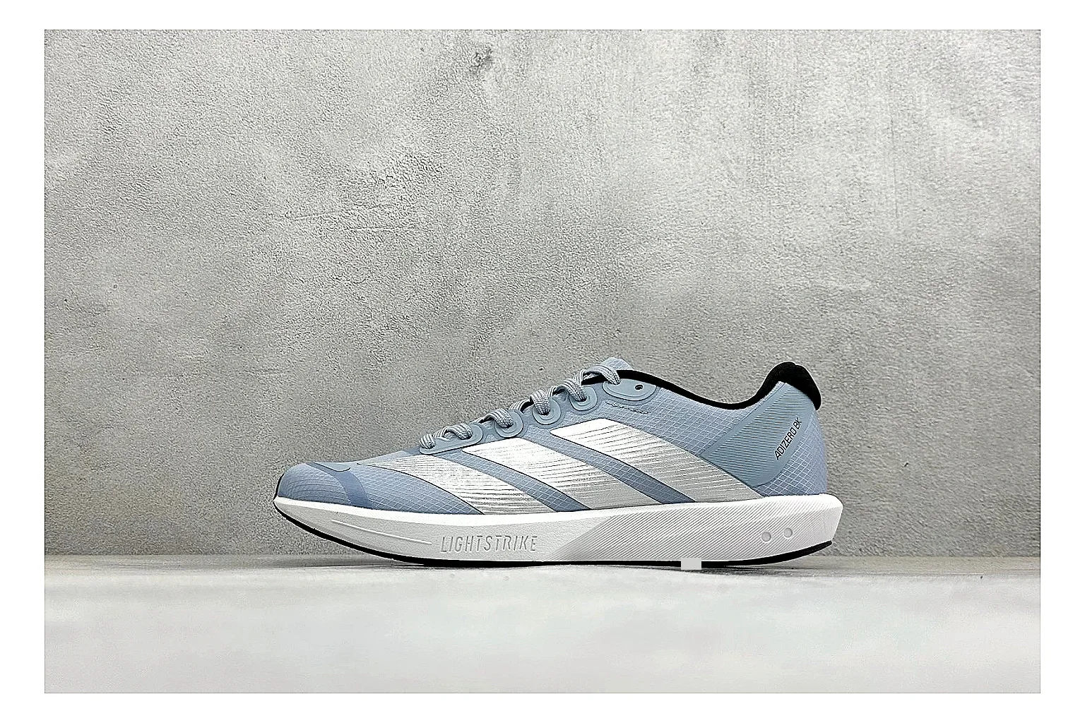 Adidas Adizero Grey Blue shopping brief photo showing grey lightweight runner upper, blue Adidas striping, slim racing shape, and low performance sole