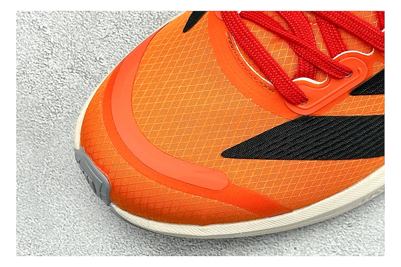 Adidas Adizero Orange Black shopping brief photo showing orange runner upper, black three-stripe contrast, lightweight racing shape, and thin performance sole thumbnail 3