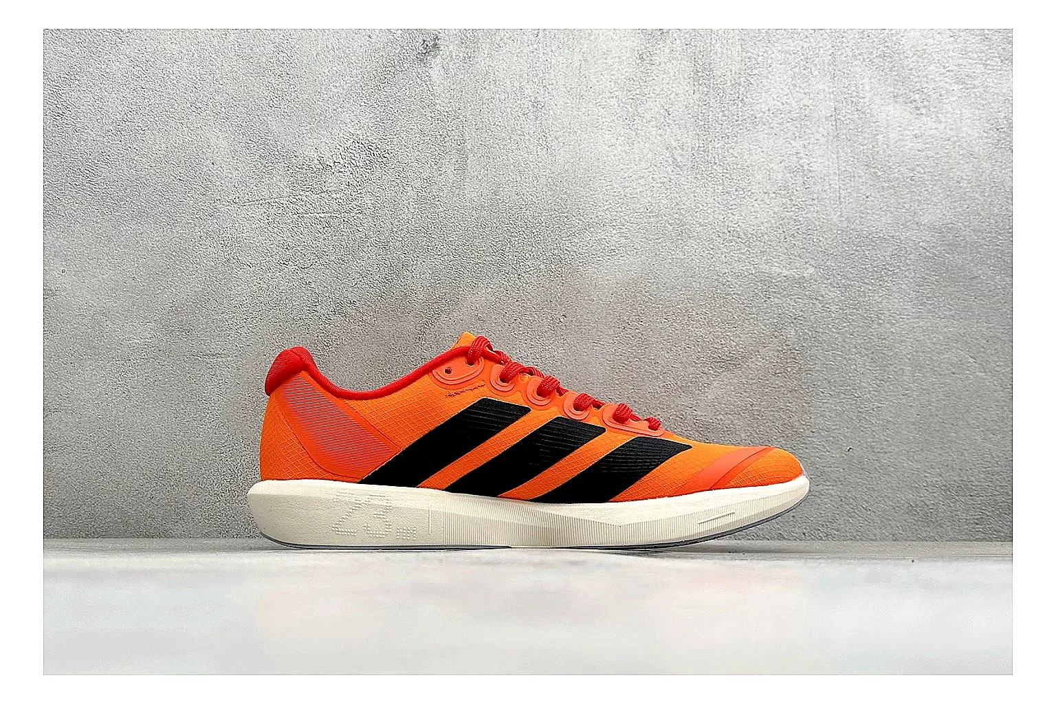 Adidas Adizero Orange Black shopping brief photo showing orange runner upper, black three-stripe contrast, lightweight racing shape, and thin performance sole thumbnail 4