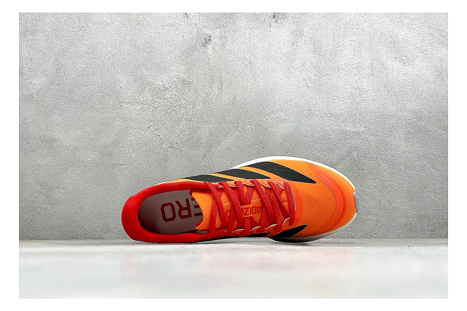 Adidas Adizero Orange Black shopping brief photo showing orange runner upper, black three-stripe contrast, lightweight racing shape, and thin performance sole thumbnail 5