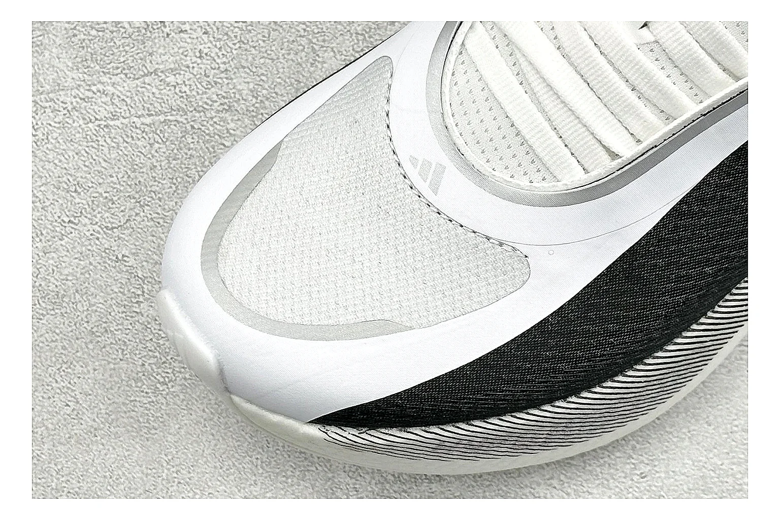 Adidas Hyper Boost White Black shopping brief photo showing white knit runner upper, black Adidas striping, sculpted Boost-style sole, and modern low runner profile thumbnail 3