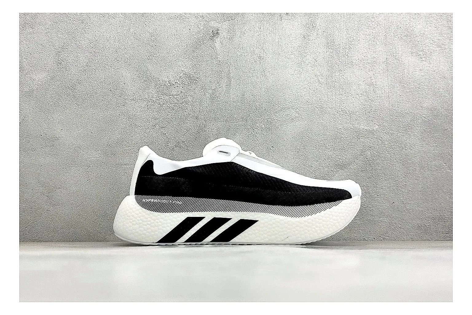 Adidas Hyper Boost White Black shopping brief photo showing white knit runner upper, black Adidas striping, sculpted Boost-style sole, and modern low runner profile thumbnail 4