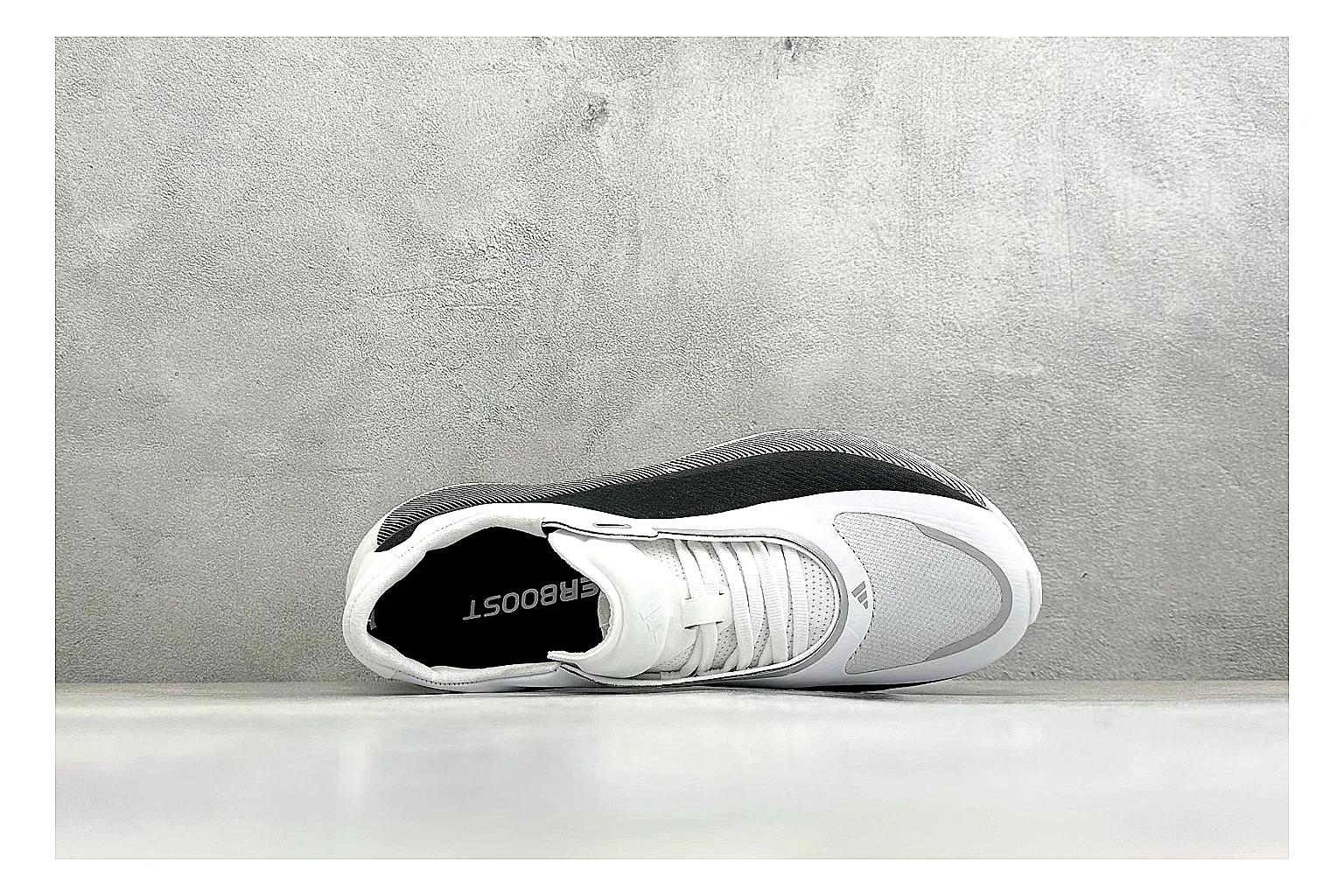 Adidas Hyper Boost White Black shopping brief photo showing white knit runner upper, black Adidas striping, sculpted Boost-style sole, and modern low runner profile thumbnail 5
