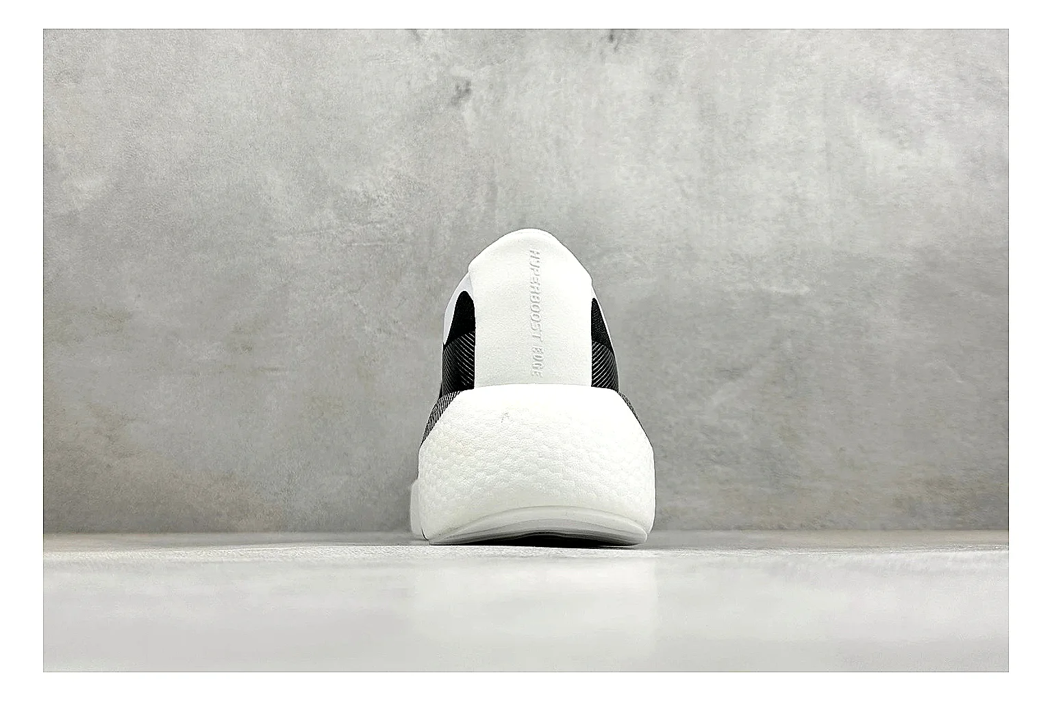 Adidas Hyper Boost White Black shopping brief photo showing white knit runner upper, black Adidas striping, sculpted Boost-style sole, and modern low runner profile thumbnail 6