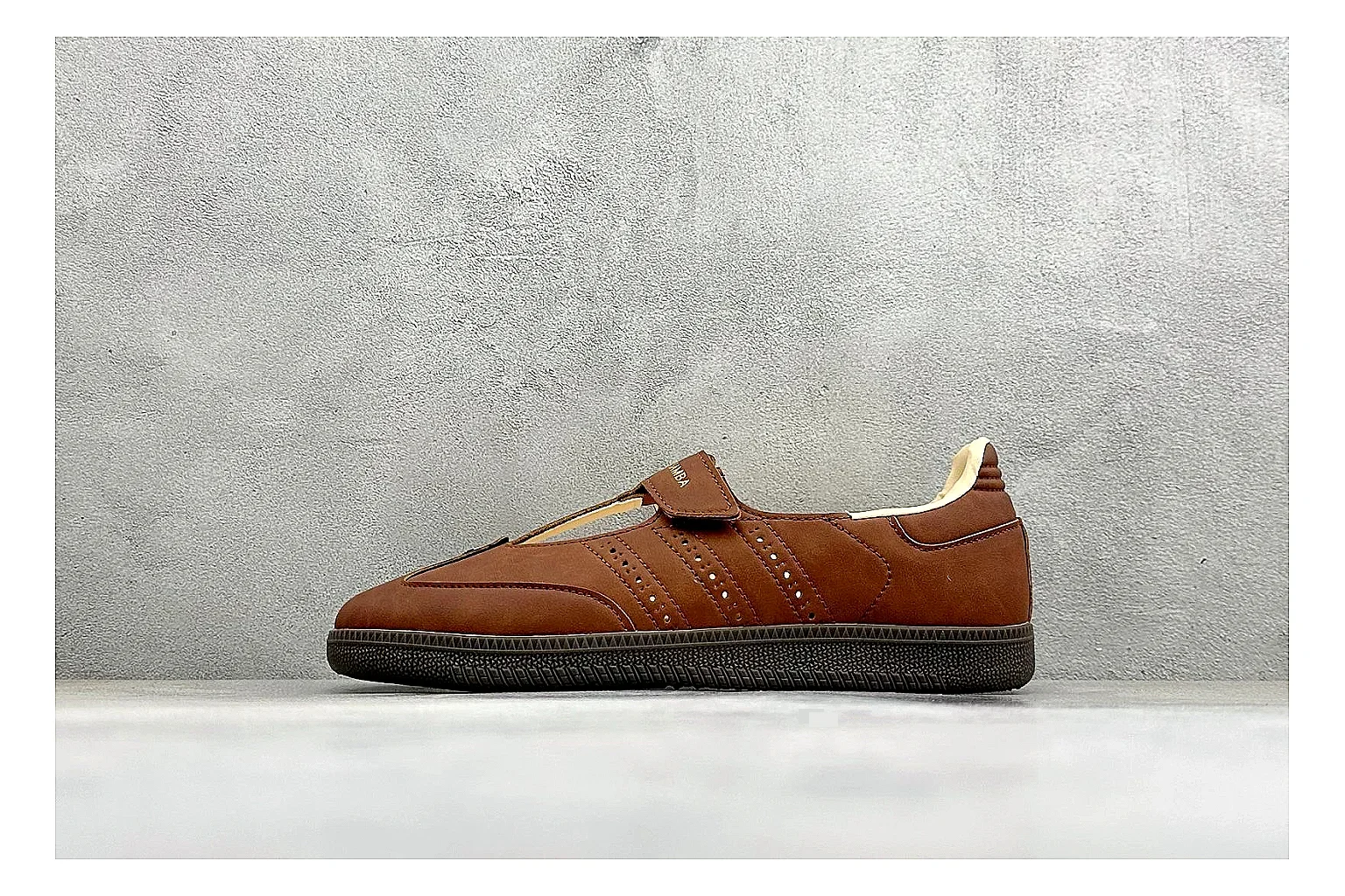 Adidas Samba Jane Brown shopping brief photo showing brown Mary Jane upper, Samba-style side stripes, strap closure, gum outsole, and low terrace profile