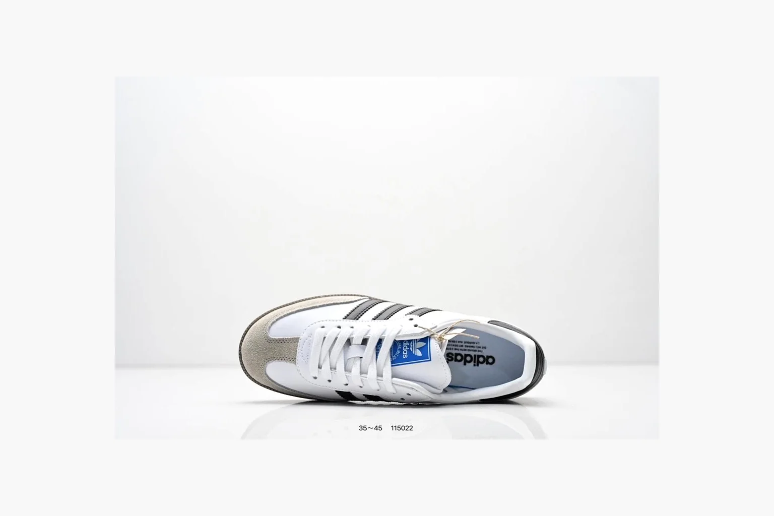 Adidas Samba OG White Black Blue shopping brief photo showing white leather-suede low-top upper, black three stripes, blue heel detail, gum terrace sole, and slim Samba profile thumbnail 5