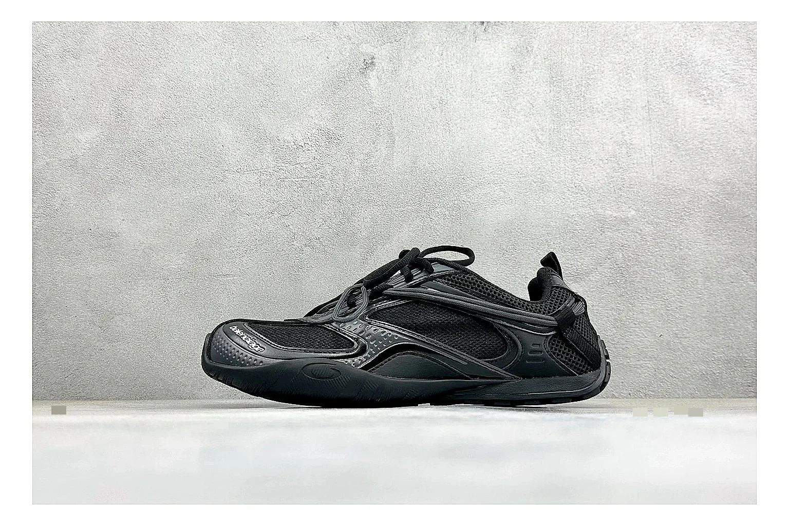 Balenciaga Track Black Low-Top shopping brief photo showing black layered technical upper, complex paneling, chunky runner sole, and tactical low-top shape