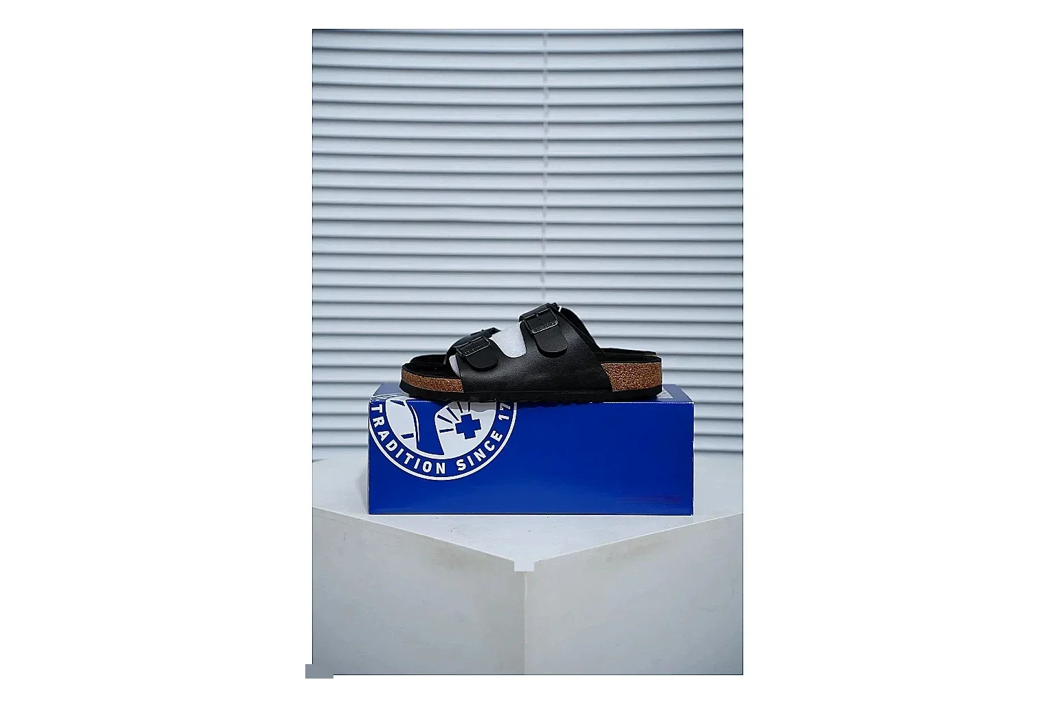 Birkenstock Arizona Black Cork Slide shopping brief image showing adjustable buckles, contoured footbed and dark outsole for versatile casual looks