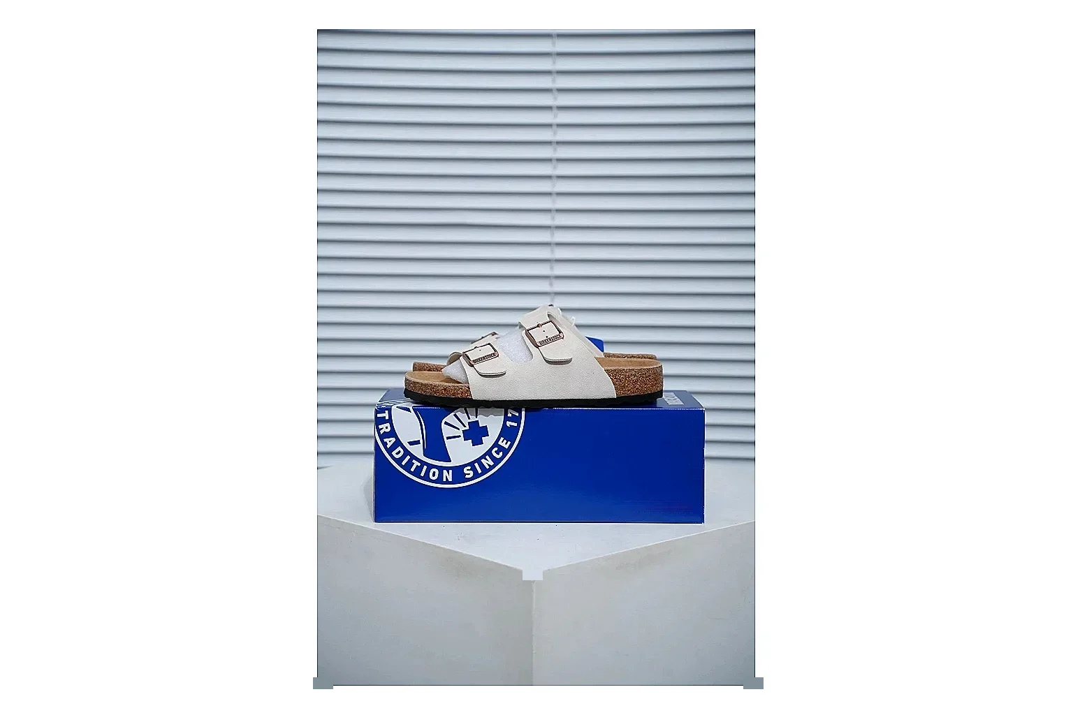 Birkenstock Arizona Cream Cork Slide shopping brief image showing adjustable buckles, soft neutral upper and contoured footbed for easy casual wear