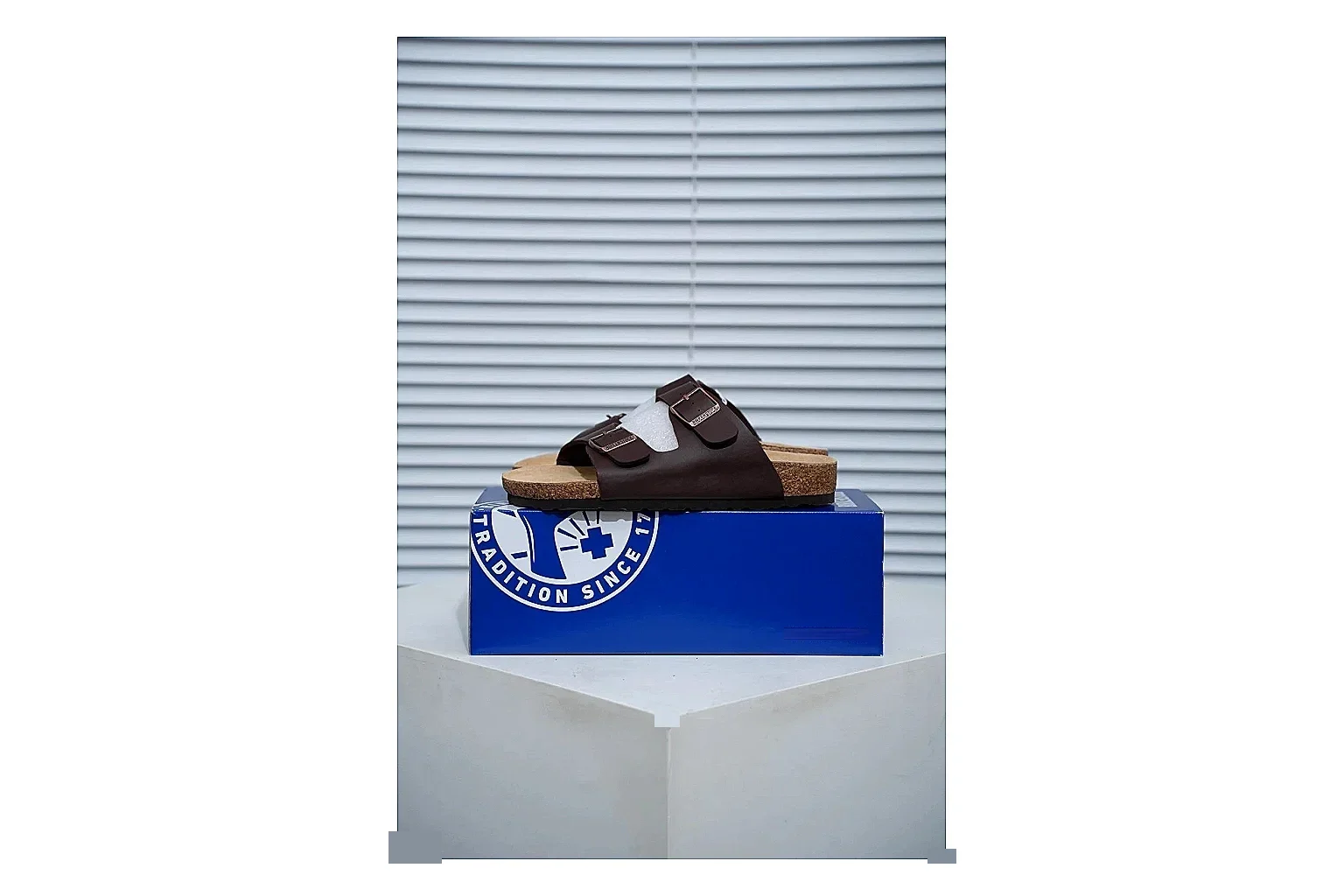 Birkenstock Arizona Mocha Cork Slide shopping brief image showing adjustable buckles, warm brown upper and contoured footbed for relaxed retro styling