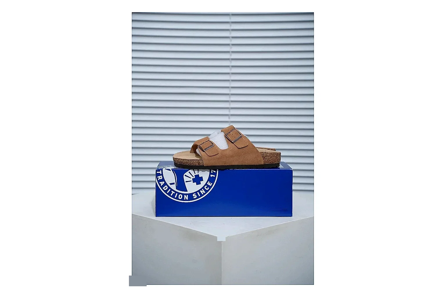 Birkenstock Arizona Tan Cork Slide shopping brief image showing warm brown upper, adjustable buckles and contoured footbed for easy casual outfits