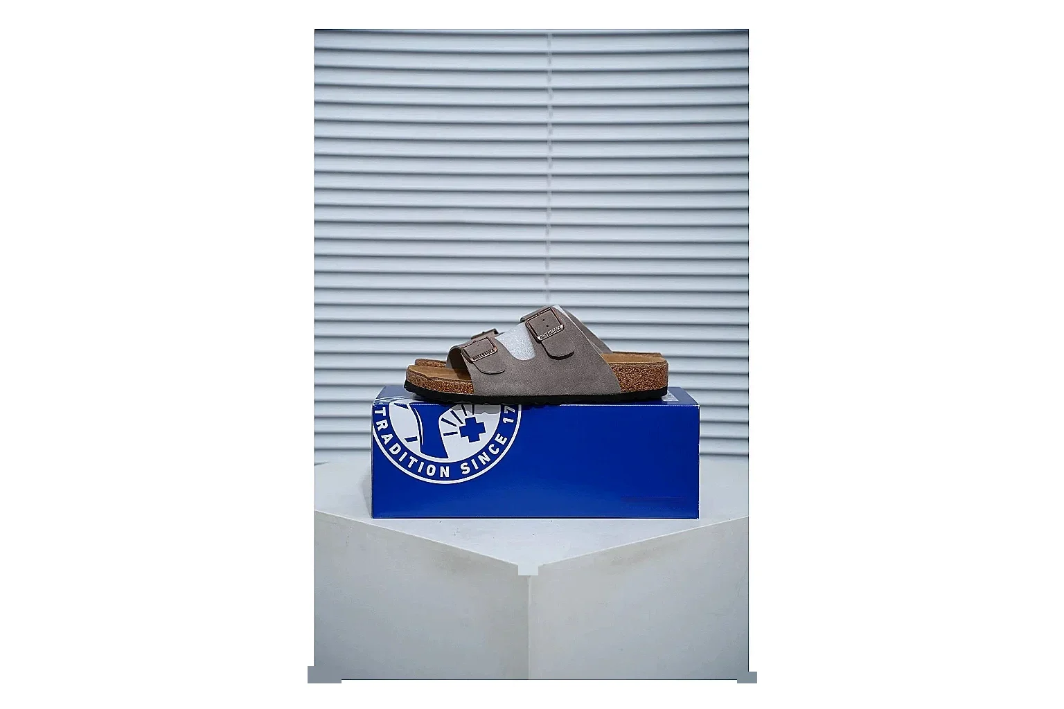Birkenstock Arizona Taupe Cork Slide shopping brief image showing suede-look upper, adjustable buckles and contoured footbed for natural everyday styling