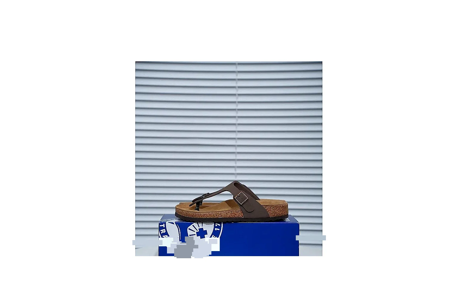 Birkenstock Brown Buckle Cork Slide shopping brief image showing wide strap, large metal buckle and contoured footbed for classic relaxed styling