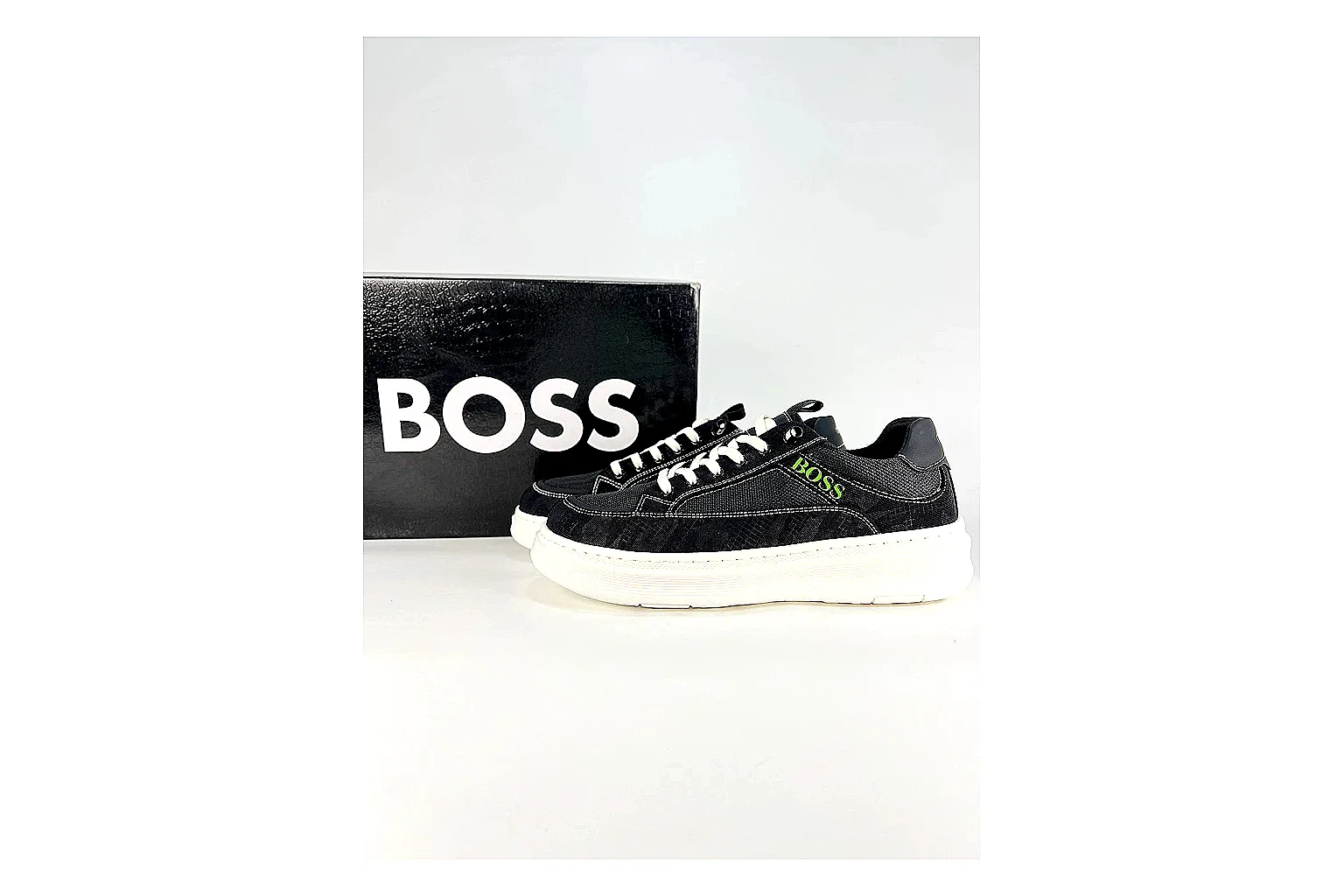 Boss Low Top Black White shopping brief photo showing black white leather low-top upper, minimal casual profile, clean panels, and simple rubber sole