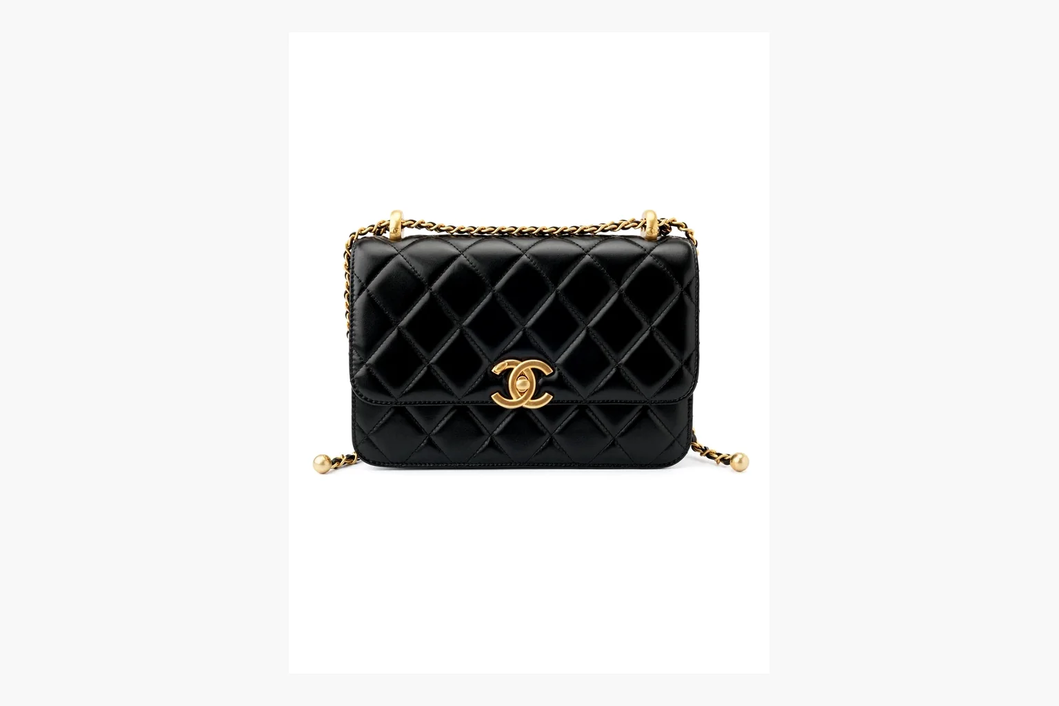 Chanel Black Quilted Chain Flap Bag shopping brief photo showing black quilted leather flap body, gold chain strap, CC front logo, rectangular shoulder-bag shape, and polished hardware