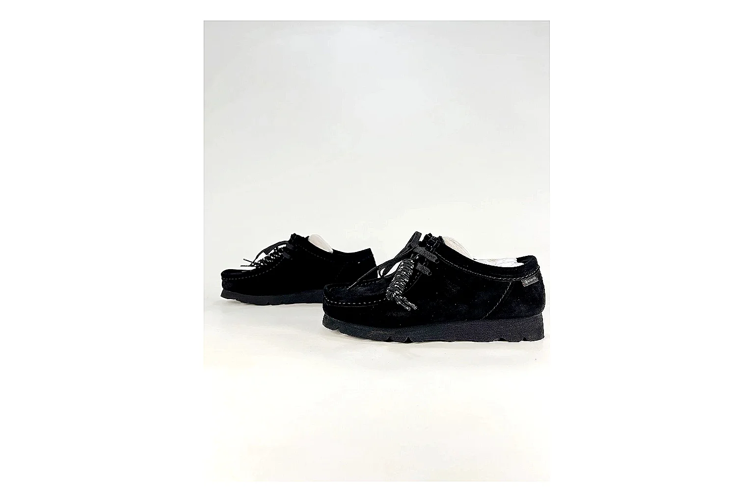 Clarks Wallabee Black Sneakers shopping brief image showing black suede Wallabee shoes with suede texture, side-profile shape, upper panel lines, and outsole detail thumbnail 3