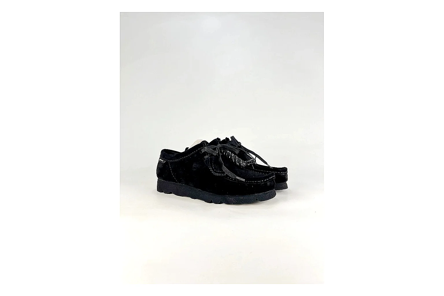 Clarks Wallabee Black Sneakers shopping brief image showing black suede Wallabee shoes with suede texture, side-profile shape, upper panel lines, and outsole detail thumbnail 4
