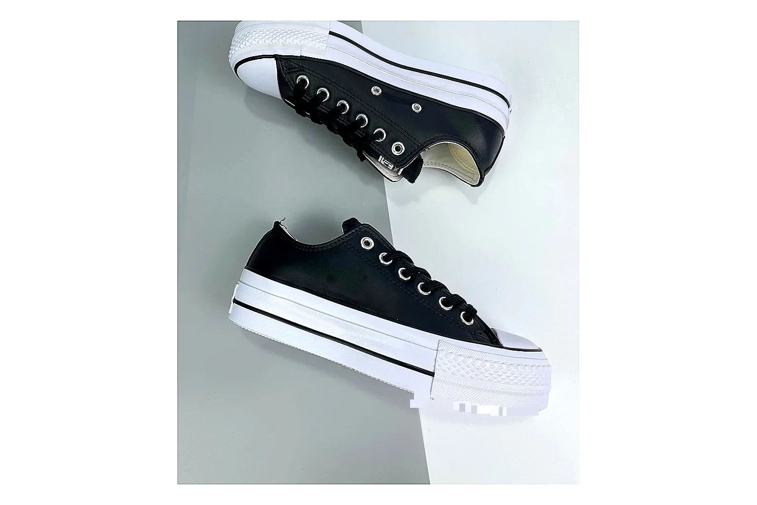 Converse All Star Lift Black Platform Low Top shopping brief photo showing black leather low-top upper, silver eyelets, white rubber toe cap, and elevated striped platform sole