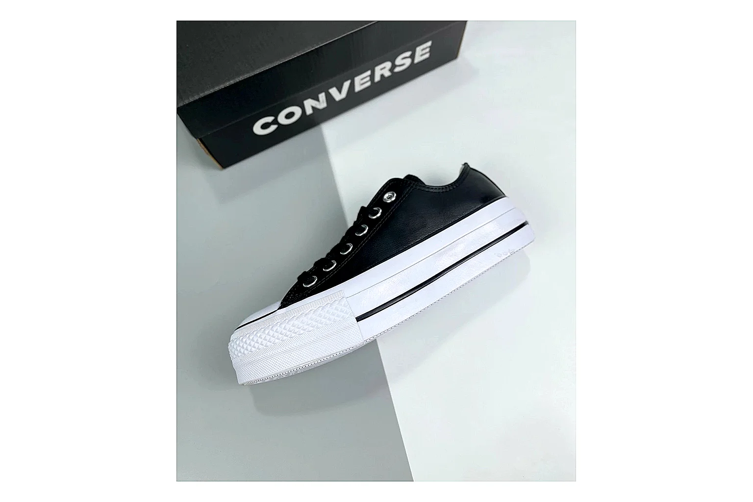 Converse All Star Lift Black Platform Low Top shopping brief photo showing black leather low-top upper, silver eyelets, white rubber toe cap, and elevated striped platform sole thumbnail 4
