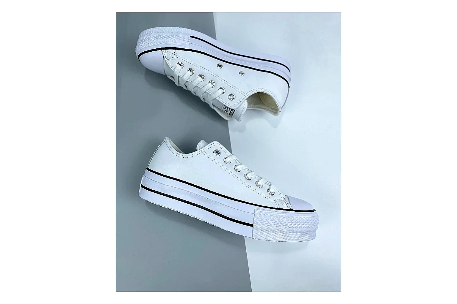 Converse All Star Lift White Platform Low Top shopping brief photo showing white smooth low-top upper, silver eyelets, black foxing stripes, and elevated platform rubber sole