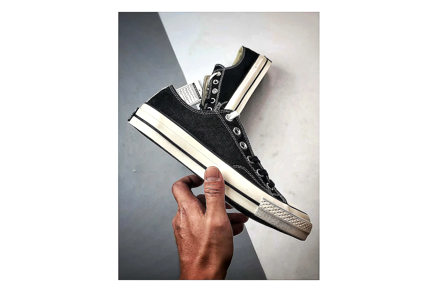 Converse Chuck Low Black White shopping brief photo showing black canvas low-top upper, white rubber toe cap, metal eyelets, and classic Converse sole thumbnail 2