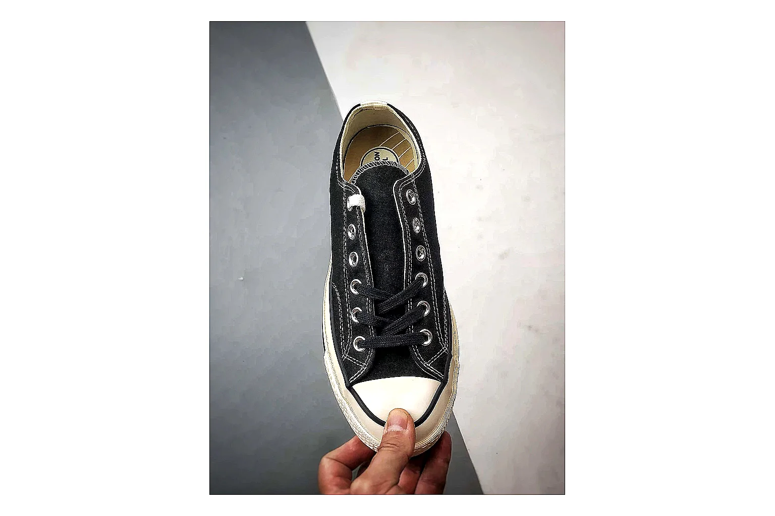 Converse Chuck Low Black White shopping brief photo showing black canvas low-top upper, white rubber toe cap, metal eyelets, and classic Converse sole thumbnail 4