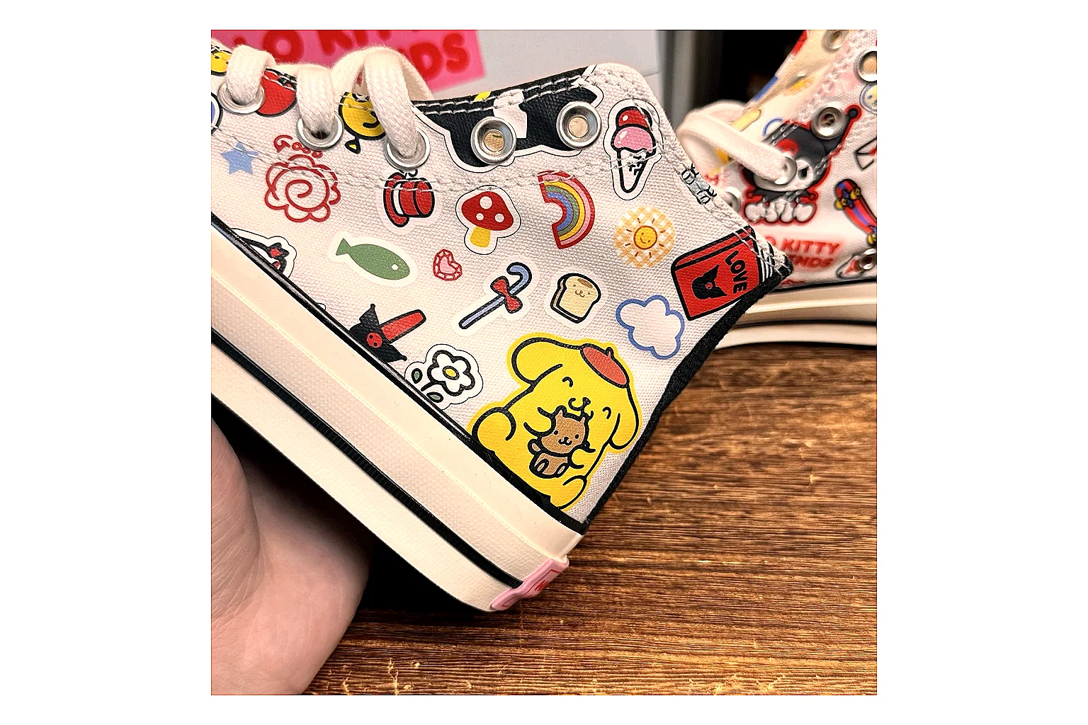 Converse Hello Kitty Chuck 70 High Top shopping brief photo showing white canvas high-top upper, colorful character graphics, metal eyelets, rubber toe cap, and elevated vintage sole thumbnail 3