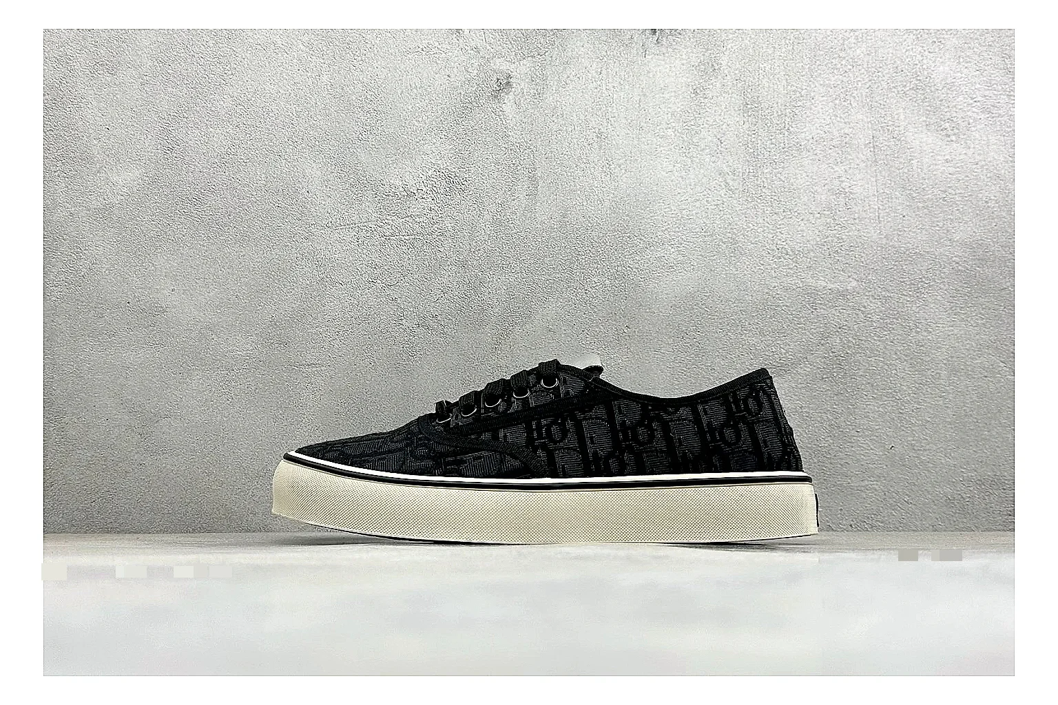 Dior Act Slide Black Low-Top shopping brief photo showing black monogram-style upper, low slip-on shape, chunky dark sole, and luxury casual profile