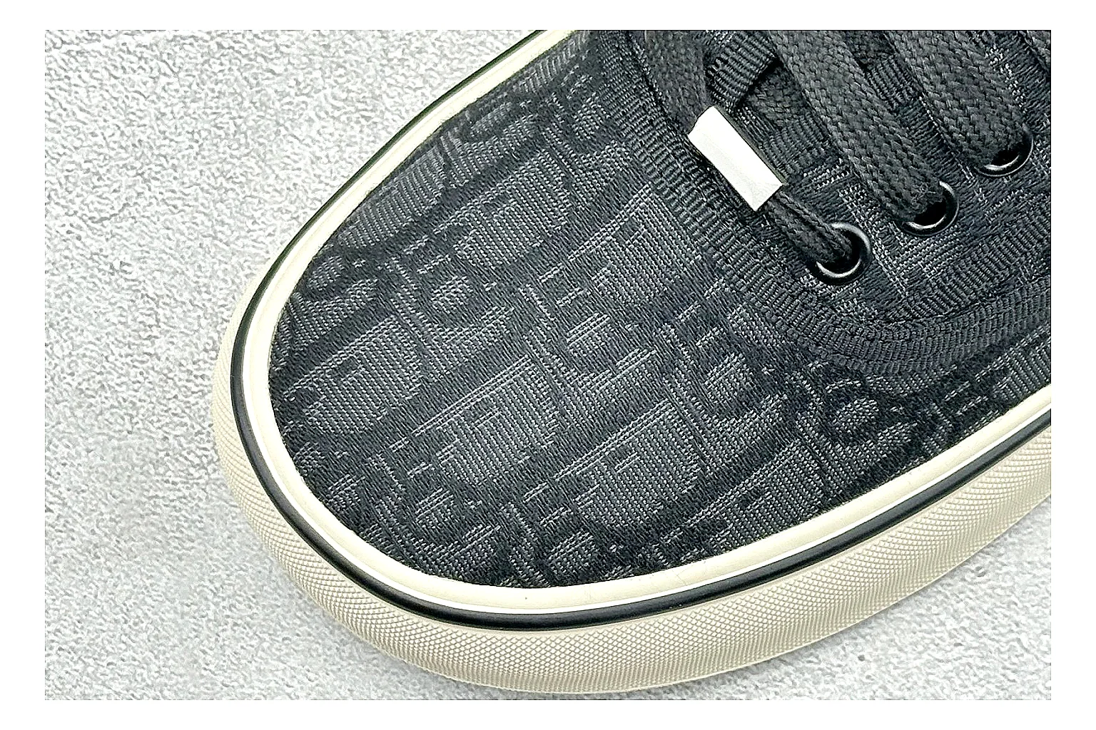 Dior Act Slide Black Low-Top shopping brief photo showing black monogram-style upper, low slip-on shape, chunky dark sole, and luxury casual profile thumbnail 3