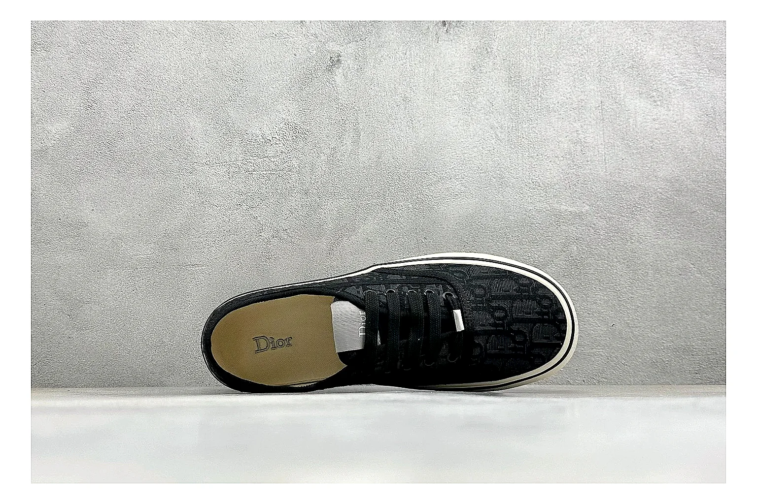 Dior Act Slide Black Low-Top shopping brief photo showing black monogram-style upper, low slip-on shape, chunky dark sole, and luxury casual profile thumbnail 5