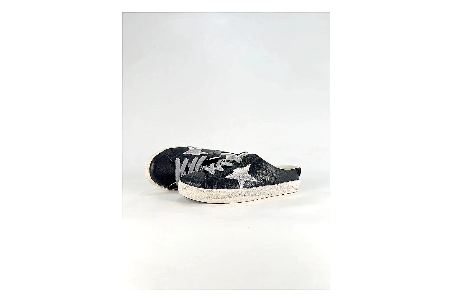 GGDB Super-Star Black White Sneakers shopping brief image showing black white distressed low-top sneakers with leather texture, side-profile shape, upper panel lines, and outsole detail thumbnail 4