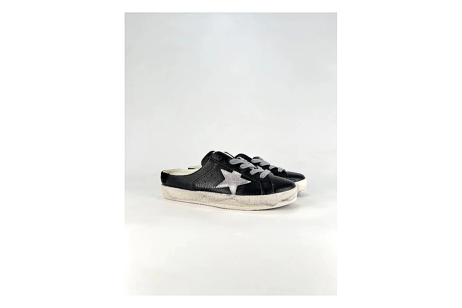 GGDB Super-Star Black White Sneakers shopping brief image showing black white distressed low-top sneakers with leather texture, side-profile shape, upper panel lines, and outsole detail thumbnail 5