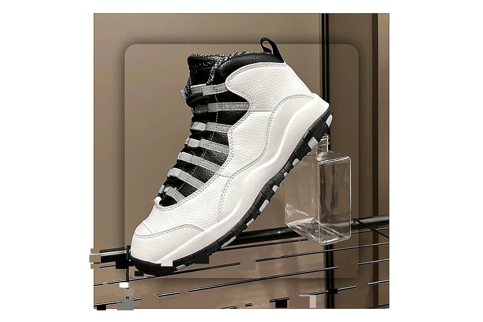 Jordan Air Jordan 10 Steel White Black shopping brief photo showing white and black high-top court upper, striped lace panels, Jumpman heel branding, and retro sole