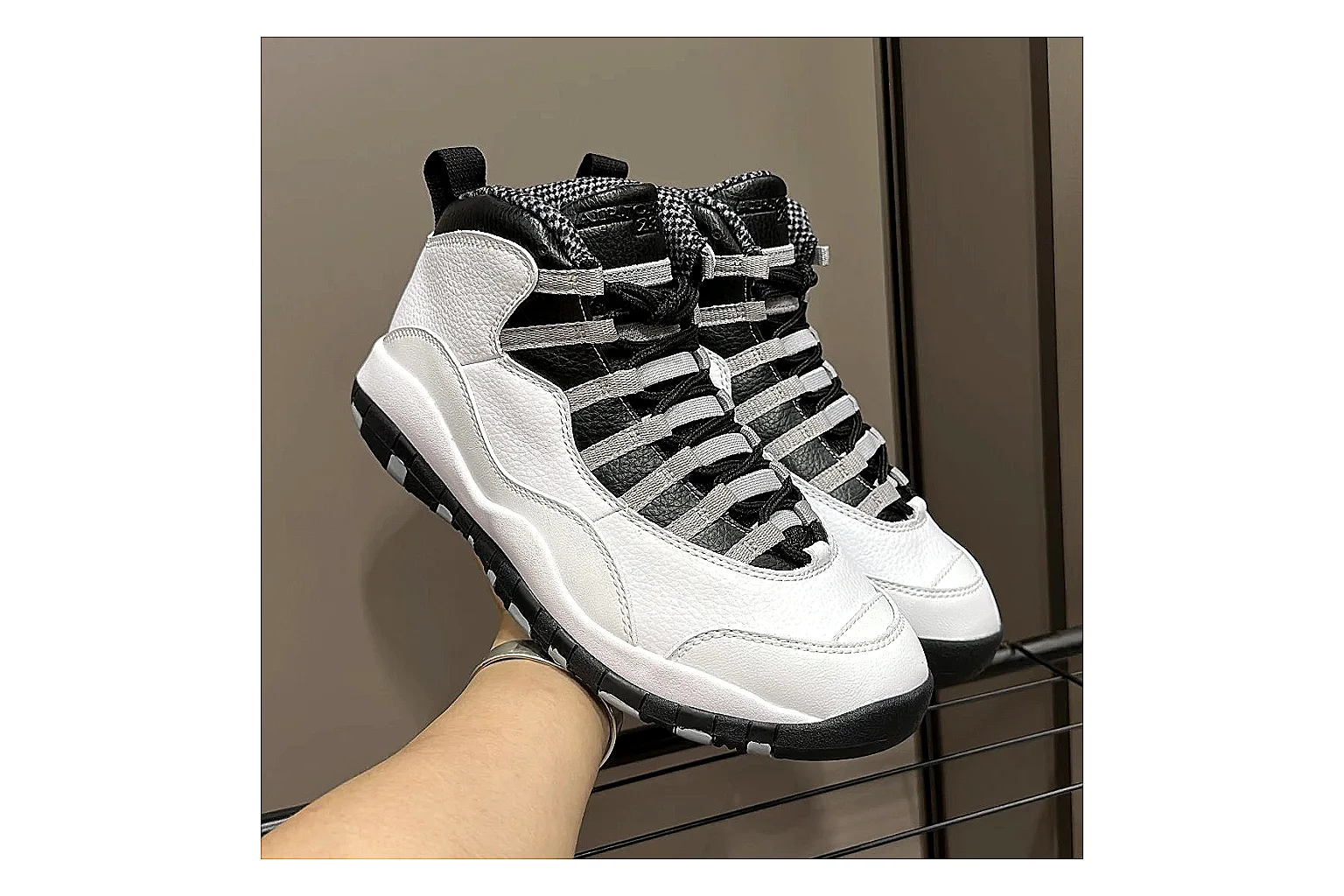 Jordan Air Jordan 10 Steel White Black shopping brief photo showing white and black high-top court upper, striped lace panels, Jumpman heel branding, and retro sole thumbnail 6