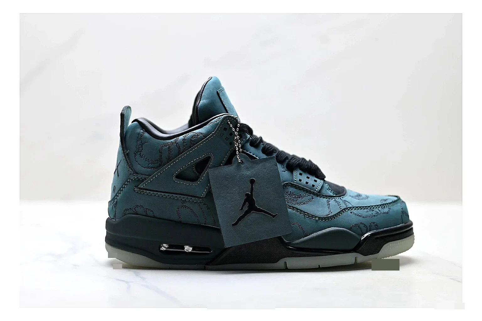 Jordan Air Jordan 4 Teal Black Sneakers shopping brief image showing teal black retro basketball sneakers with nubuck texture, side-profile shape, upper panel lines, and outsole detail