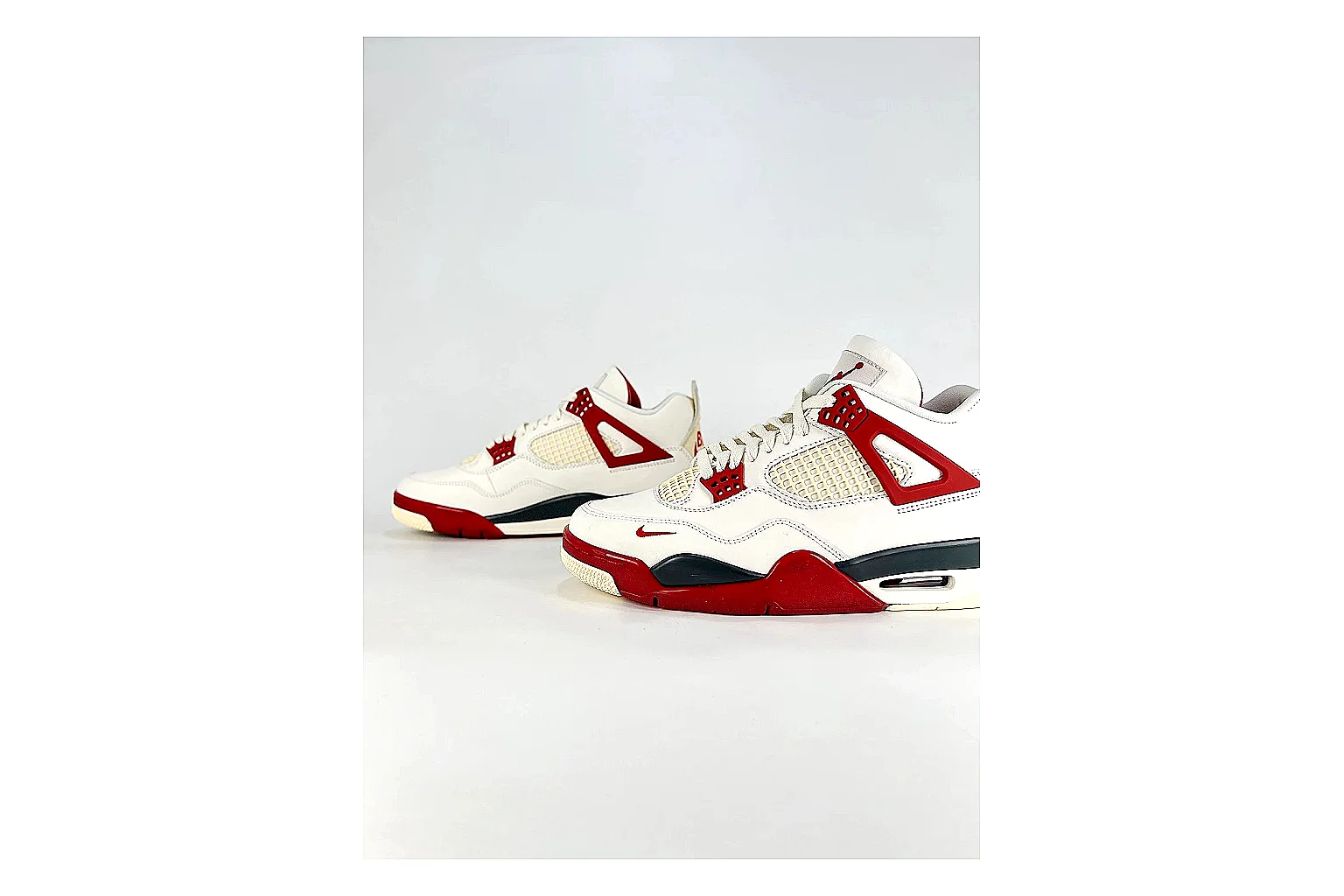 Jordan Air Jordan 4 White Red Sneakers shopping brief image showing white red retro basketball sneakers with leather texture, side-profile shape, upper panel lines, and outsole detail thumbnail 3