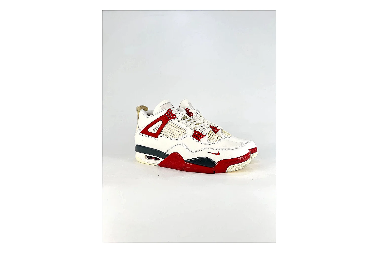 Jordan Air Jordan 4 White Red Sneakers shopping brief image showing white red retro basketball sneakers with leather texture, side-profile shape, upper panel lines, and outsole detail thumbnail 4