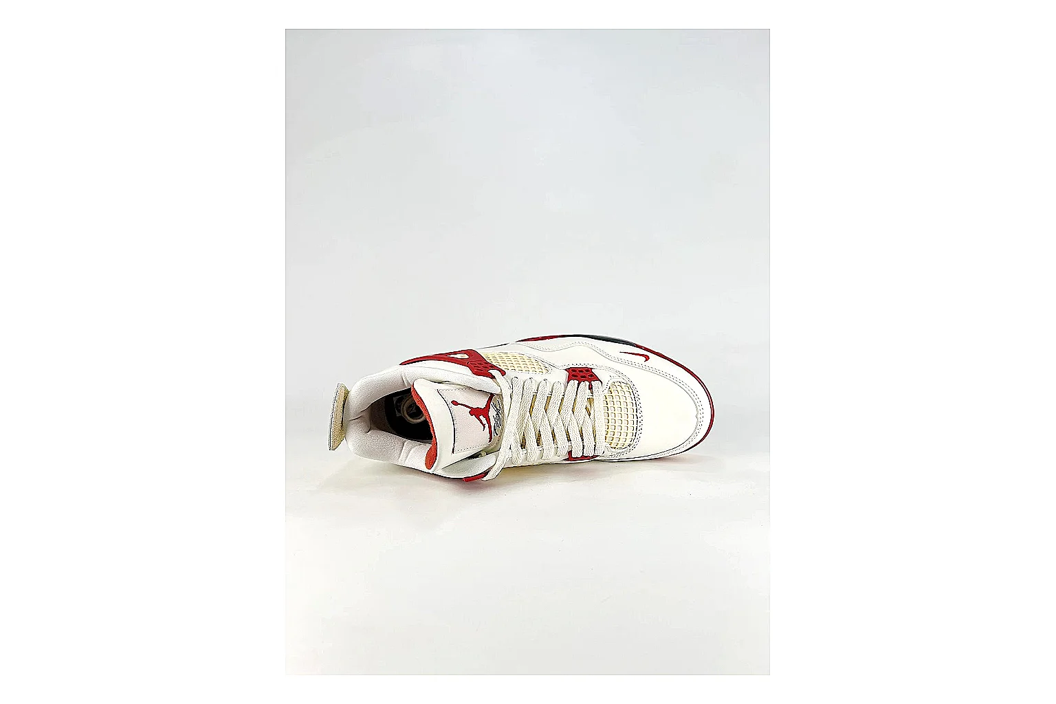 Jordan Air Jordan 4 White Red Sneakers shopping brief image showing white red retro basketball sneakers with leather texture, side-profile shape, upper panel lines, and outsole detail thumbnail 5