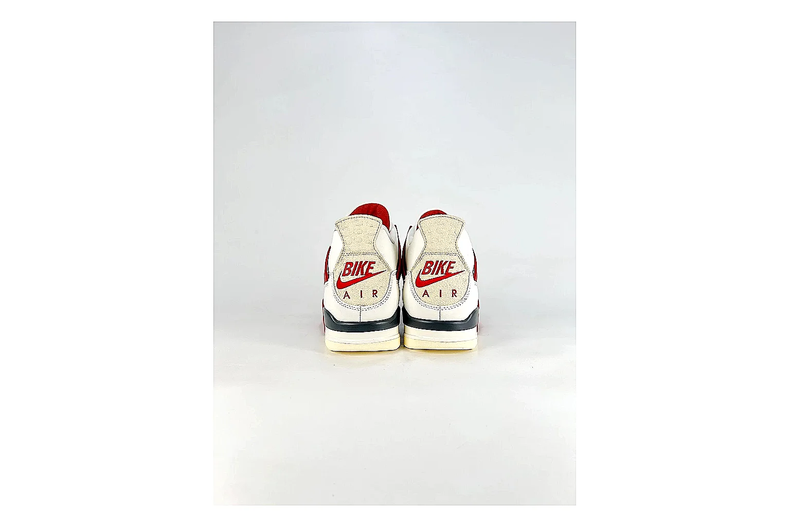 Jordan Air Jordan 4 White Red Sneakers shopping brief image showing white red retro basketball sneakers with leather texture, side-profile shape, upper panel lines, and outsole detail thumbnail 6