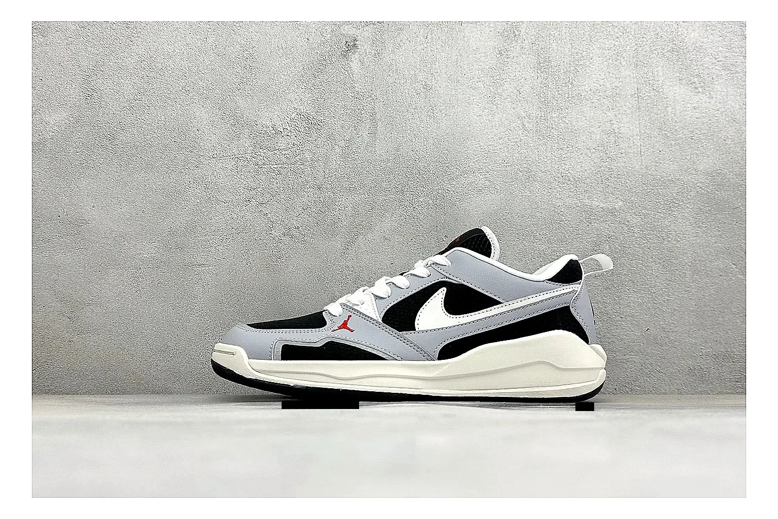 Jordan CMFT Black White shopping brief photo showing black and white layered panels, low padded collar, visible Jordan styling cues, and a compact court sole