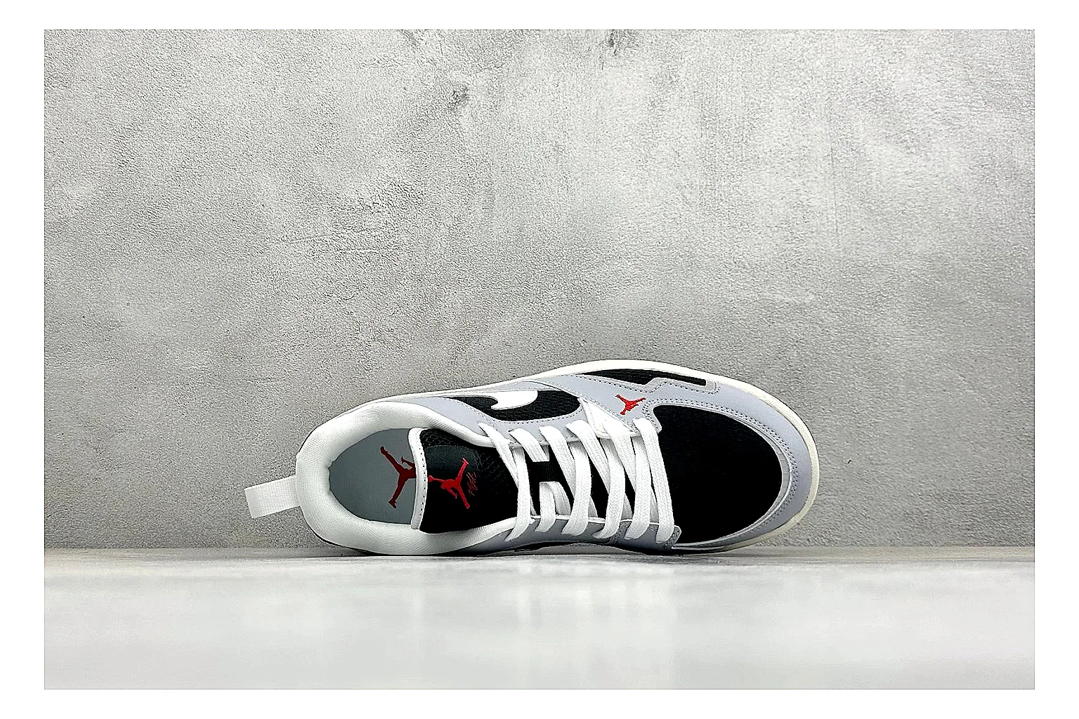 Jordan CMFT Black White shopping brief photo showing black and white layered panels, low padded collar, visible Jordan styling cues, and a compact court sole thumbnail 5