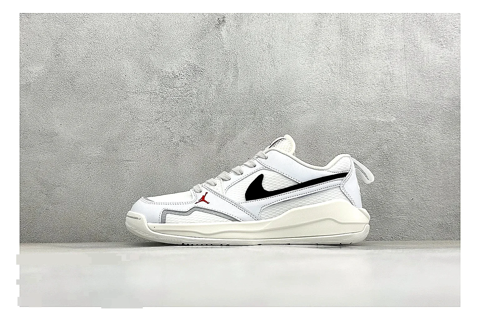Jordan CMFT White Black shopping brief photo showing white and black layered court panels, red logo detail, low collar, and a clean contrast sole