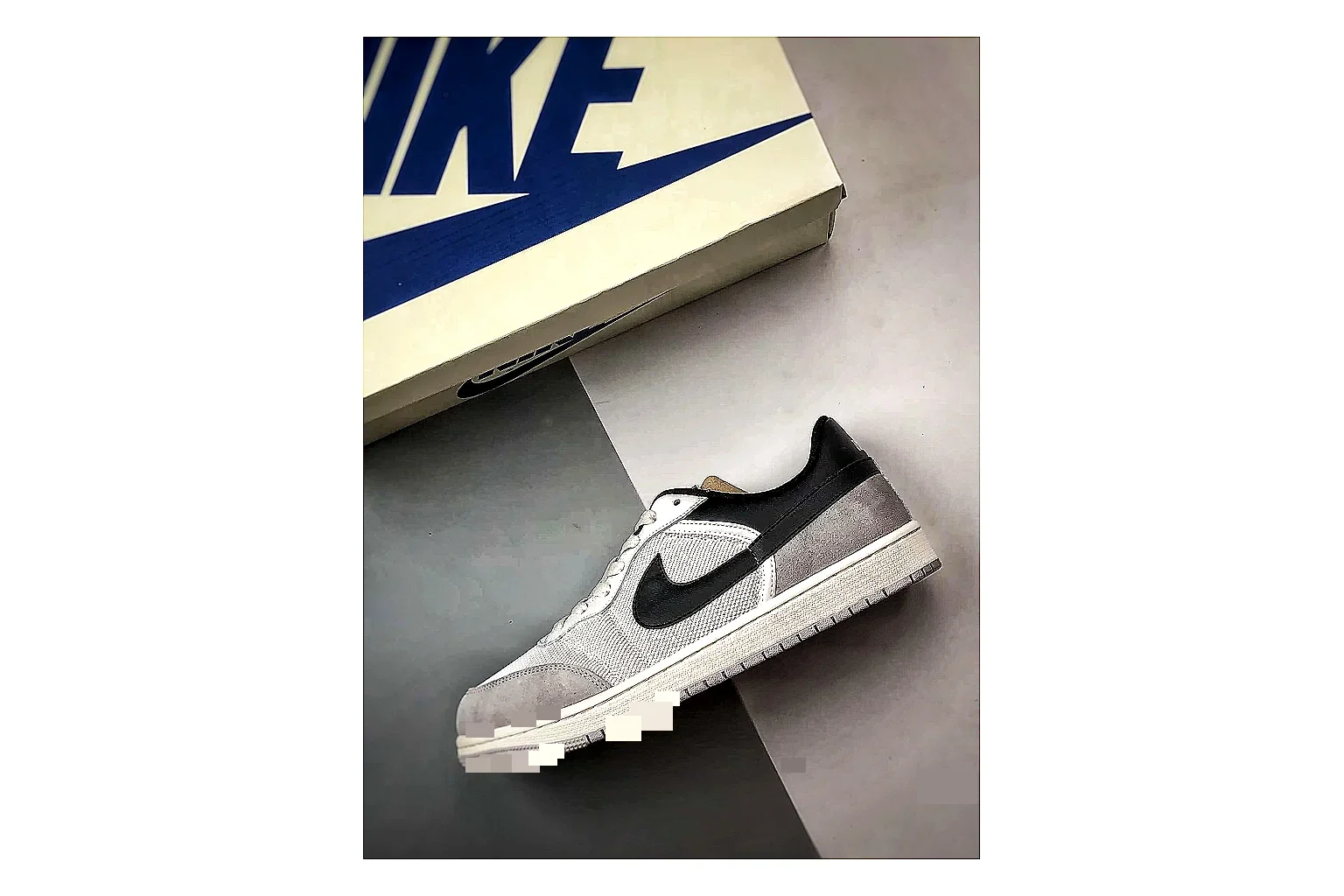 Jordan Low Black White Sneaker shopping brief image showing white black low-top sneaker with mixed-material upper and low-profile shape