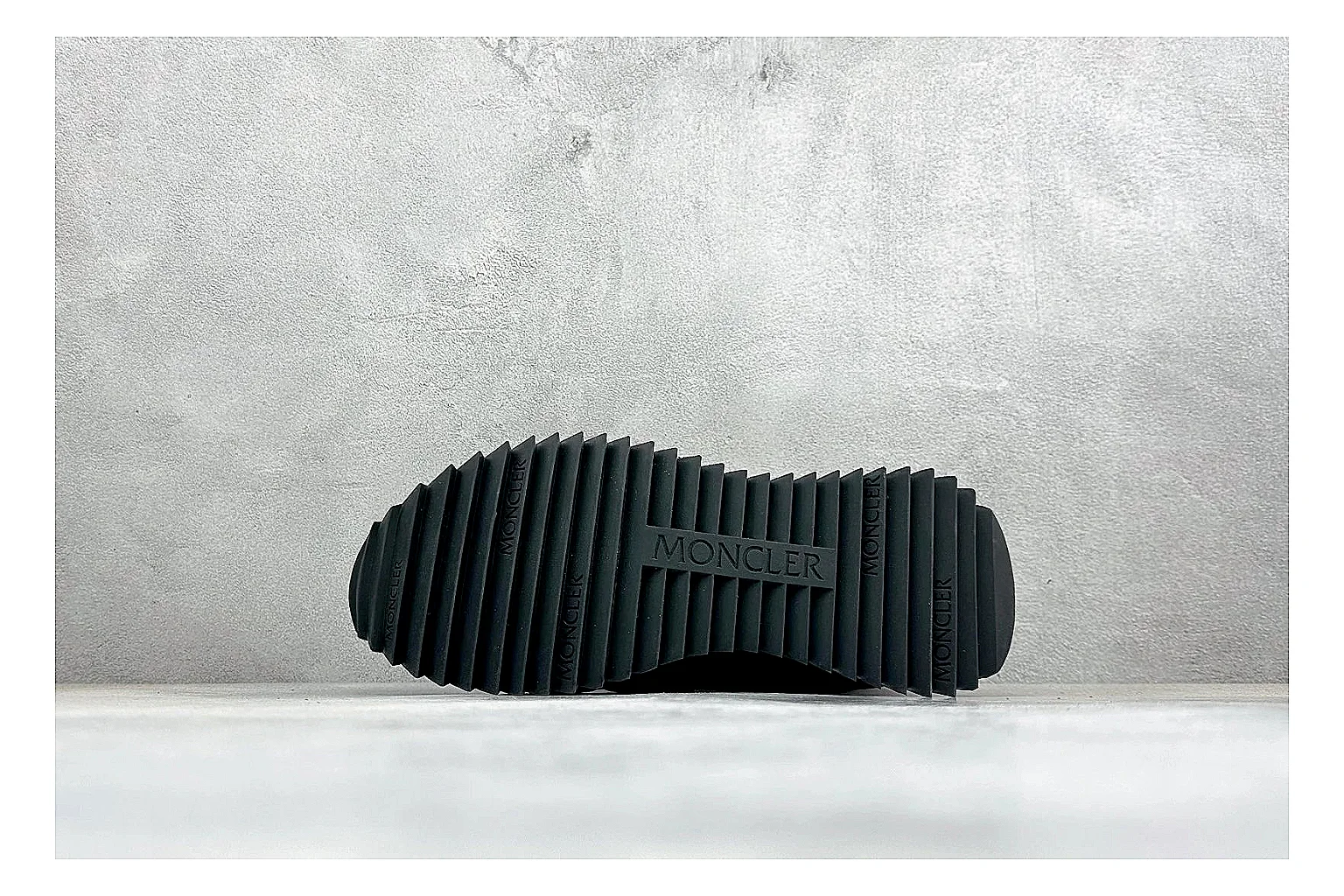Moncler Pacey Black White shopping brief image showing black upper, white rugged outsole, low padded collar, and outdoor-leaning tread profile thumbnail 2