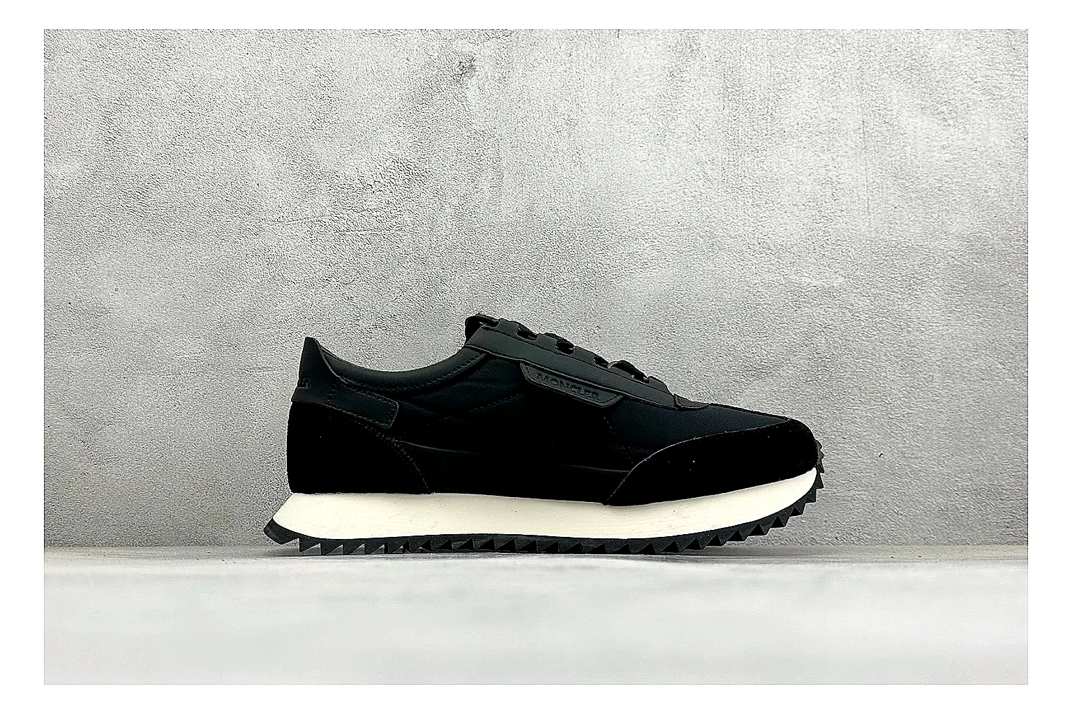 Moncler Pacey Black White shopping brief image showing black upper, white rugged outsole, low padded collar, and outdoor-leaning tread profile thumbnail 4