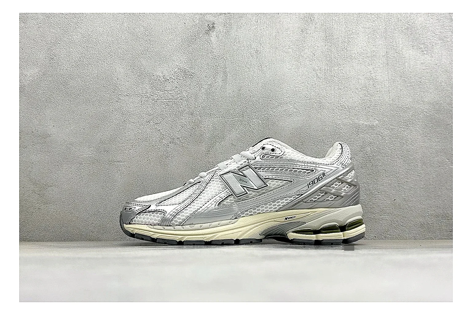 New Balance 1906 Silver Grey shopping brief image showing silver overlays, grey mesh panels, technical runner structure, and layered midsole tooling