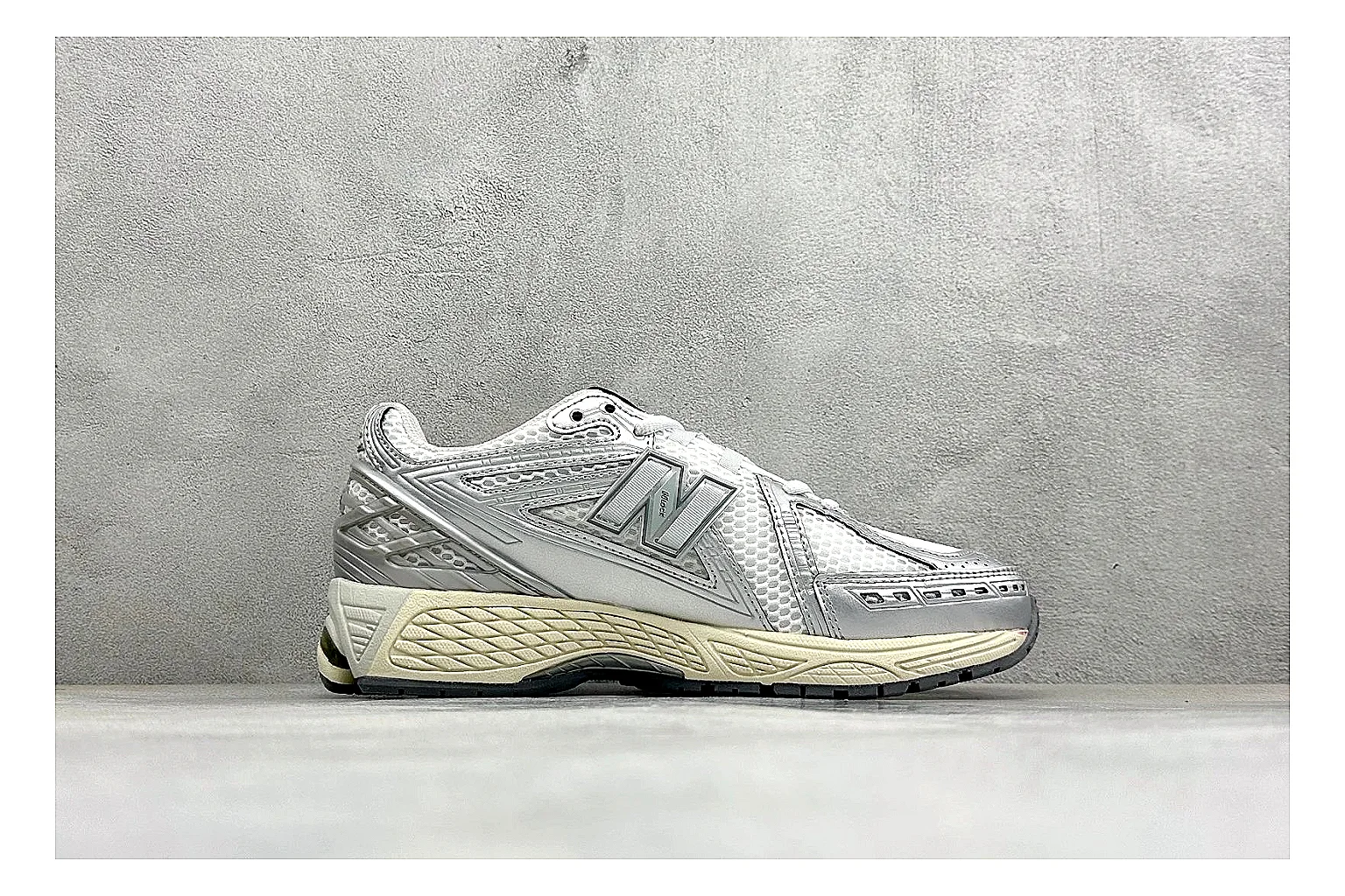 New Balance 1906 Silver Grey shopping brief image showing silver overlays, grey mesh panels, technical runner structure, and layered midsole tooling thumbnail 4